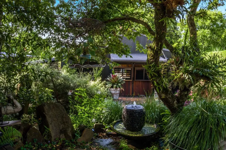 the barn, spied through the water feature