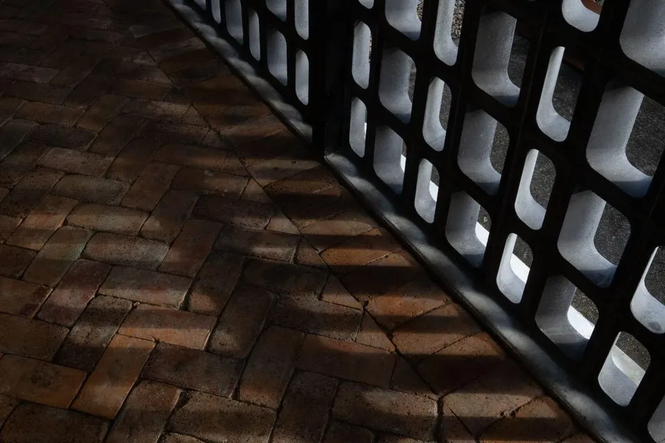 the breeze-block wall catching the light